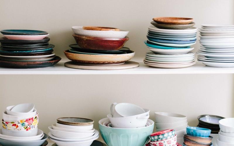 a shelf with bowls and plates on it
